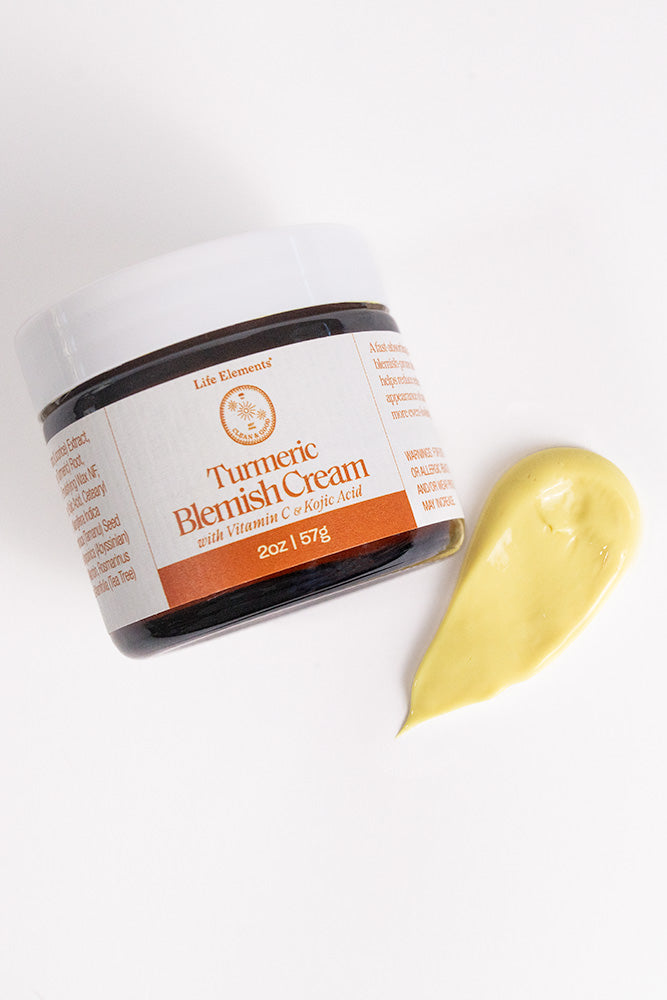 Jar of Turmeric Blemish Cream with a Swipe of Cream from Life Elements